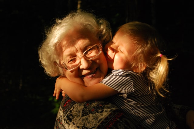 old lady and little girl hug